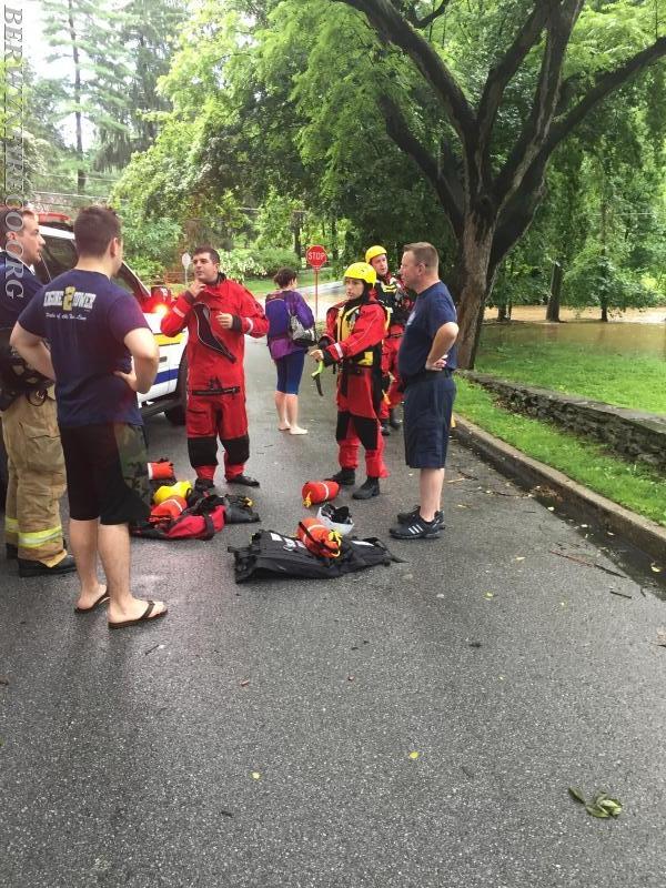 Rescuers debrief after rescuing one occupant from their vehicle along Trout Creek in the Glenhardie section of Tredyffrin Township in June of 2017.