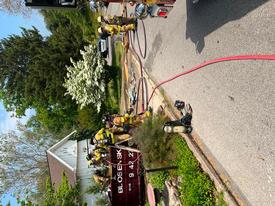 Berwyn and Paoli firefighters working together at a dumpster fire in the 1000 block of Waterloo Rd. in Easttown Twp.